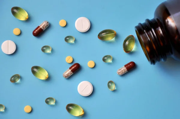Pills Pills Vitamins Scattered Jar Blue Background — Stock Photo, Image