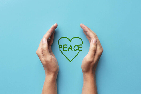 The word peace is in the hands of man. Symbol of protection of peaceful life