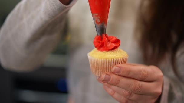 Close Red Icing Squeezing Cupcake Female Caucasian Hand Unrecognizable Woman — Stock Video