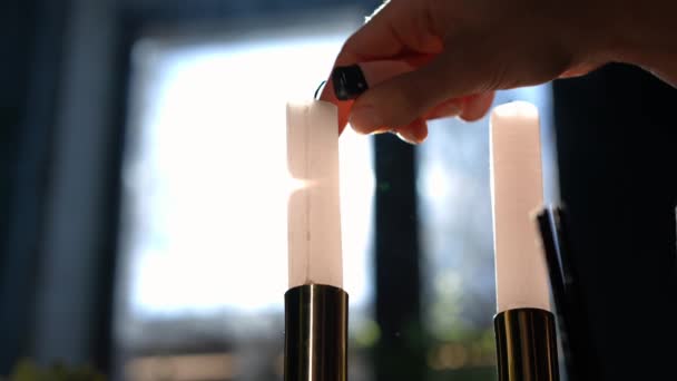 Две Свечи Подсвечнике Тонкой Женской Молодой Рукой Светящейся Зажигалкой Неузнаваемая — стоковое видео