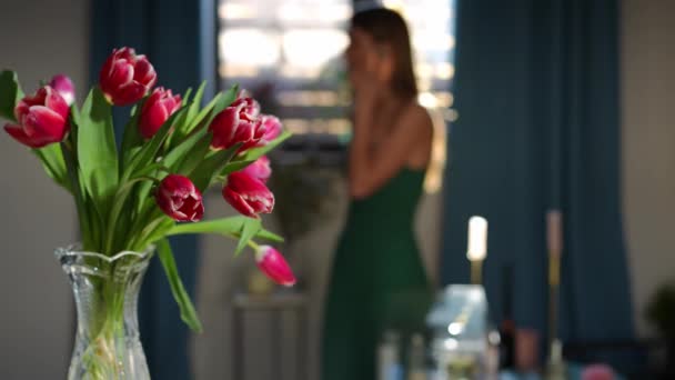 Blumenstrauß Drinnen Mit Einer Unzufriedenen Gestressten Frau Die Hintergrund Telefoniert — Stockvideo