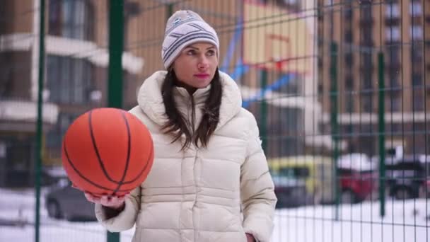 Portrait Motivated Confident Sportswoman Basketball Ball Standing Snowy Sports Ground — Stock Video