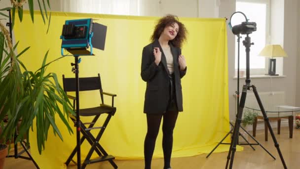 Wide Shot Positive Young Female Blogger Filming Vlog Yellow Background — Vídeos de Stock
