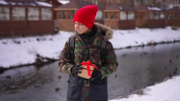 Anxious Teenage Boy Standing Gift Box Winter Day River Waiting — Video Stock