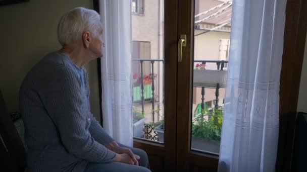 Sad Lonely Old Woman Looking Out Window Sitting Left Indoors — Stockvideo
