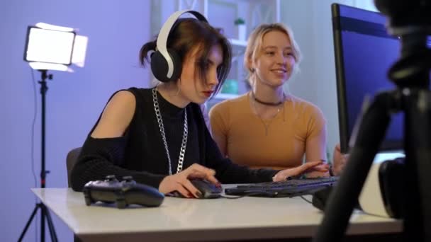 Concentrated Serious Millennial Woman Gaming Blurred Friend Talking Supporting Sitting — Stockvideo