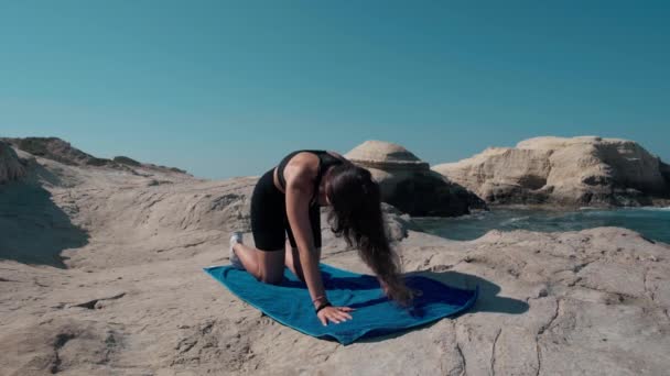 Wide Shot Motivated Yogi Bending Cat Pose Coast Mediterranean Sea — 비디오