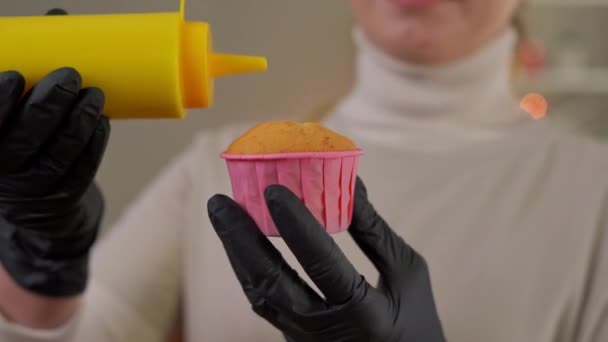 Muffin Cerca Forma Rosa Con Mano Femenina Guantes Vertiendo Líquido — Vídeo de stock