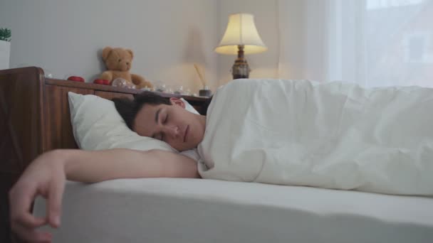 Νεαρός Άνδρας Κοιμάται Στο Κρεβάτι Γυναίκα Ξυπνάει Στο Παρασκήνιο Αφήνοντας — Αρχείο Βίντεο