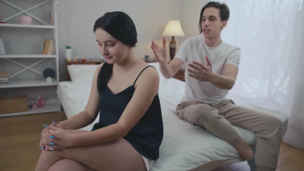 Frustrated Young Woman Sitting Bed Blurred Man Yelling Background Looking — Stock Video