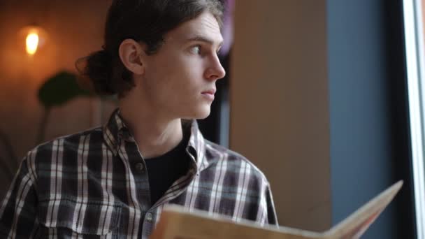 Yavaş Çekimde Kitap Okuyan Zeki Bir Gencin Pencereden Dışarı Bakan — Stok video