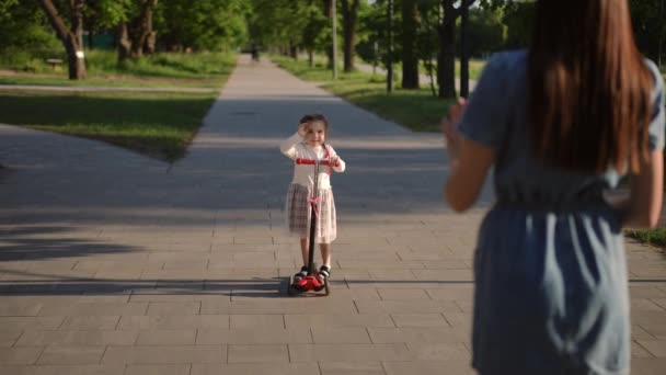 Wide Shot Excited Little Girl Scooter Waving Slow Motion Blurred — Stock Video