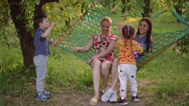 Ευτυχισμένη Χαλαρή Νεαρές Γυναίκες Που Κάθονται Αιώρα Αλίευση Σαπουνόφουσκες Παιδιά — Αρχείο Βίντεο