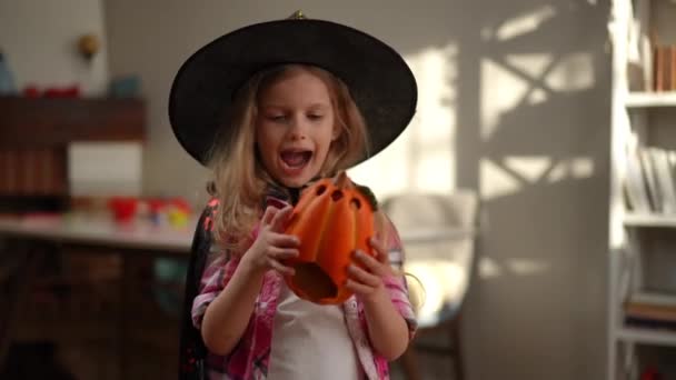 Cheerful Girl Costume Making Faces Playing Halloween Pumpkin Indoors Portrait — Stock Video