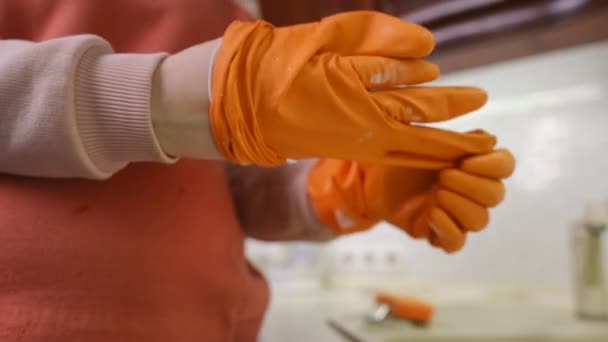 Close Unrecognizable Woman First Takes Puts Orange Rubber Glove While — Stock Video