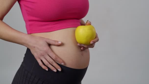 Zbliżenie Ciężarna Kobieta Trzyma Żółte Jabłko Jednej Ręce Delikatnie Głaska — Wideo stockowe