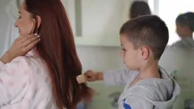 Bir çocuk banyodayken uzun saçlı bir kadını sevgiyle tararken yürekler acısı bir an yaşanıyor.