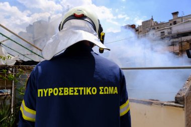 Firefighters try to extinguish the fire breaks out in abandoned building in central Athens, Greece on August 17, 2022. clipart