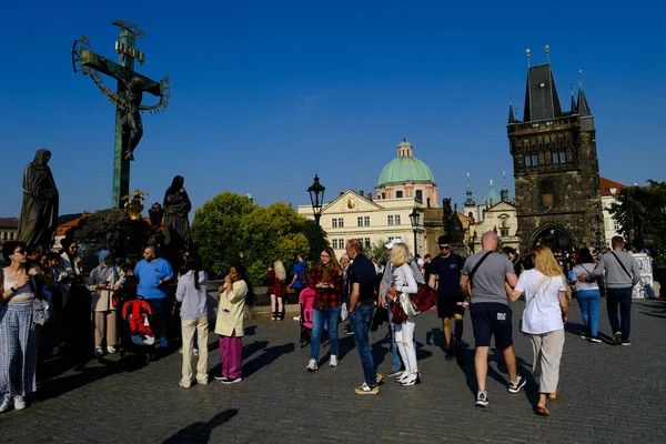 stock image Crowd of tourists walking in famous Charles Bridge  in Prague, Czech Republic on July 27, 2022.