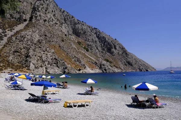 stock image People enjoy the sun and the sea in beach of Symi Dodecanese, Greece on August 1, 2022.