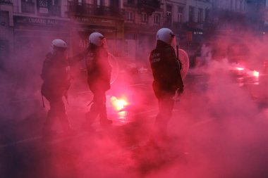 Protestors clashed with riot police after the Qatar 2022 World Cup football match between Belgium and Morocco, in Brussels, Belgium on November 27, 2022.  clipart