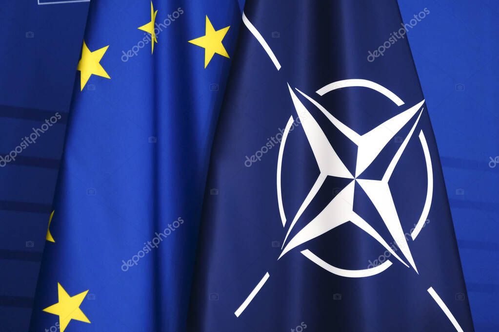 Flag of European Union and flag of NATO in European Commission Building in Brussels, Belgium on  January 11, 2023.