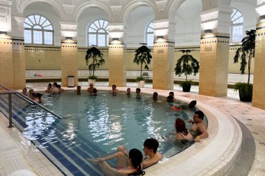 People enjoy the healing springs in the Szechenyi Medicinal Bath in Budapest, Hungary in December 22, 2022.