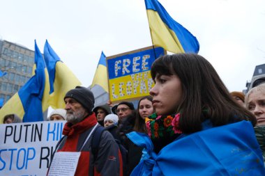 Protestors hold signs and wave Ukrainian flags during a demonstration in support of Ukraine outside of an EU headquarters in Brussels, Belgium , Jan. 23, 2023. 
