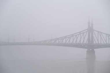 View of Margaret bridge  during a foggy day in Budapest, Hungary on December 23, 2022.