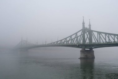 View of Margaret bridge  during a foggy day in Budapest, Hungary on December 23, 2022.