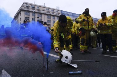 Fire emerges next to a helmet on the road as firefighters protest against violence they encountered during intervention and for better working conditions, in Brussels, Belgium, January 27, 2023.