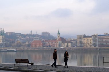 People stroll central street of Budapest during a foggy day in Hungary on December 23, 2022