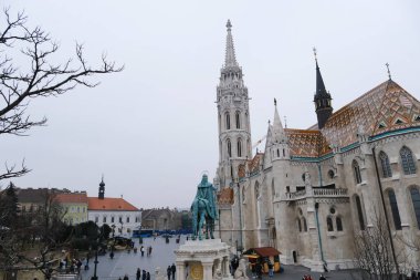 Tourists visit the Fisherman's Bastion during a foggy day in Budapest, Hungary on December 21, 2022.