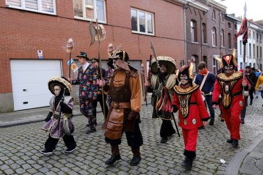Revellers and Carvivalists celebrate during the traditional carnival parade in Binche, Belgium on 19th Feb. 2023.