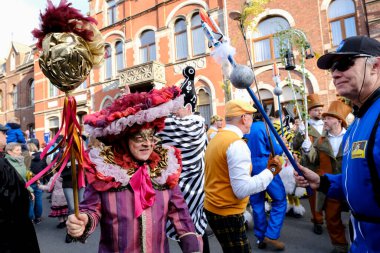Revellers and Carvivalists celebrate during the traditional carnival parade in Binche, Belgium on 19th Feb. 2023.