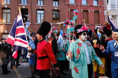 Revellers and Carvivalists celebrate during the traditional carnival parade in Binche, Belgium on 19th Feb. 2023.