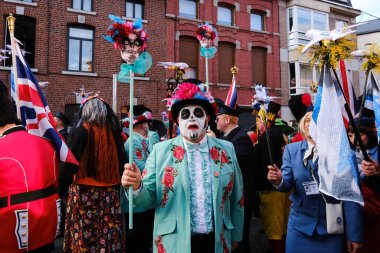Revellers and Carvivalists celebrate during the traditional carnival parade in Binche, Belgium on 19th Feb. 2023.