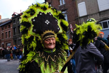 Revellers and Carvivalists celebrate during the traditional carnival parade in Binche, Belgium on 19th Feb. 2023.