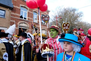 Revellers and Carvivalists celebrate during the traditional carnival parade in Binche, Belgium on 19th Feb. 2023.