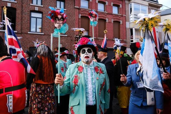 Revellers and Carvivalists celebrate during the traditional carnival parade in Binche, Belgium on 19th Feb. 2023.