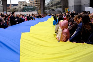 Supporters of Ukraine unfurl a giant flag in front of the EU Parliament building on the first anniversary of the Russian invasion, in Brussels, Belgium February 24, 2023.