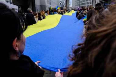 Supporters of Ukraine unfurl a giant flag in front of the EU Parliament building on the first anniversary of the Russian invasion, in Brussels, Belgium February 24, 2023.