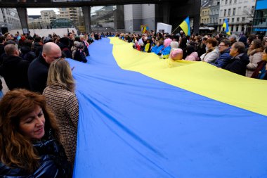 Supporters of Ukraine unfurl a giant flag in front of the EU Parliament building on the first anniversary of the Russian invasion, in Brussels, Belgium February 24, 2023.