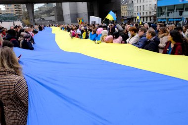 Supporters of Ukraine unfurl a giant flag in front of the EU Parliament building on the first anniversary of the Russian invasion, in Brussels, Belgium February 24, 2023.