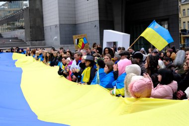 Supporters of Ukraine unfurl a giant flag in front of the EU Parliament building on the first anniversary of the Russian invasion, in Brussels, Belgium February 24, 2023.