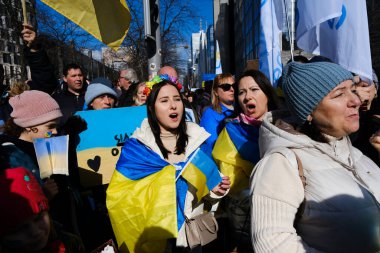Several thousand people take part in a demonstration for the first anniversary of the Russian invasion in Brussels, Belgium on Feb. 25, 2023.