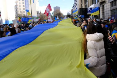Supporters of Ukraine unfurl a giant flag during a demonstration for the first anniversary of the Russian invasion in Brussels, Belgium on Feb. 25, 2023.