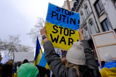 Several thousand people take part in a demonstration for the first anniversary of the Russian invasion in Brussels, Belgium on Feb. 25, 2023.