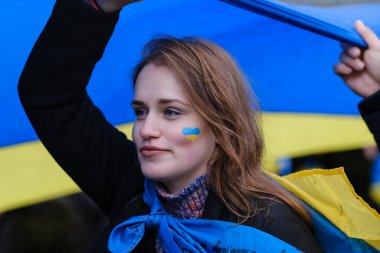 Supporters of Ukraine unfurl a giant flag during a demonstration for the first anniversary of the Russian invasion in Brussels, Belgium on Feb. 25, 2023.