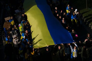 Supporters of Ukraine unfurl a giant flag during a demonstration for the first anniversary of the Russian invasion in Brussels, Belgium on Feb. 25, 2023.